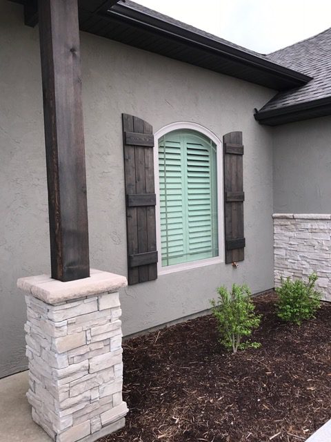 Shutters are a perfect complement for arched windows installed by Columbia Blinds and Shutters